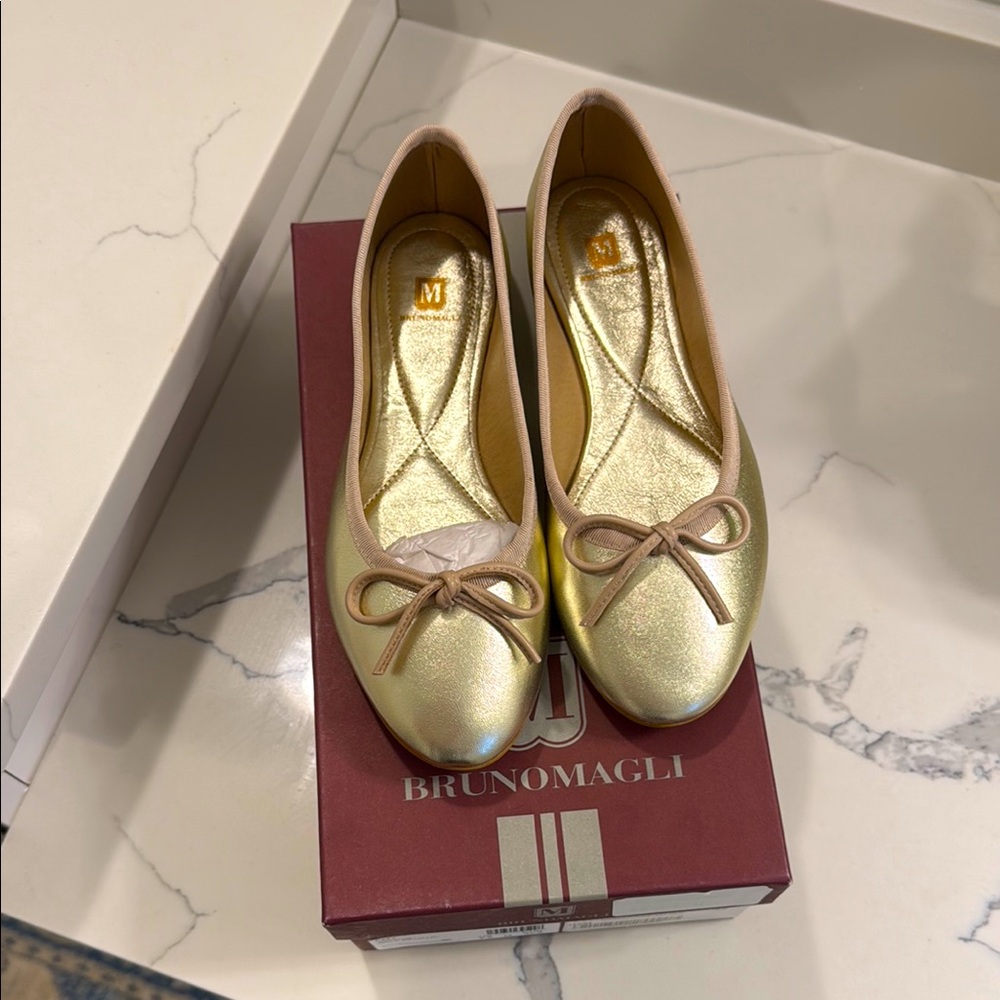 NWT - Brand new in box beautiful Bruno Magli gold metallic flats. 7.5 / 37.5